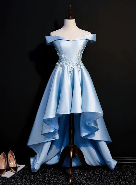 Light blue satin high-low homecoming dress with lace applique, worn by a model.