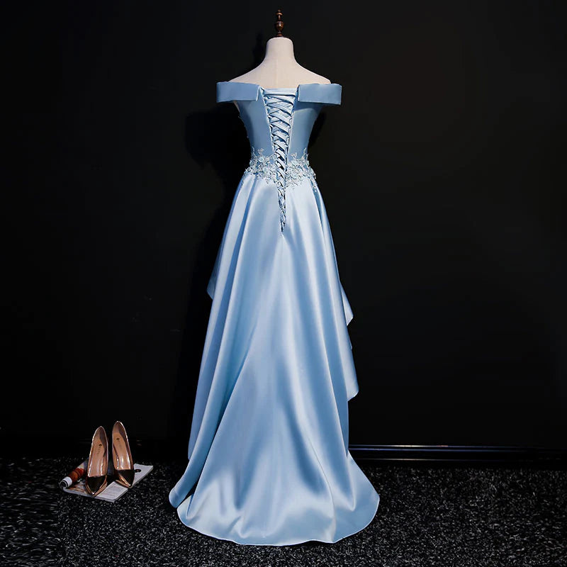 Close-up of the light blue satin fabric and lace applique on the off-shoulder dress.