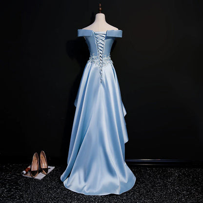 Close-up of the light blue satin fabric and lace applique on the off-shoulder dress.