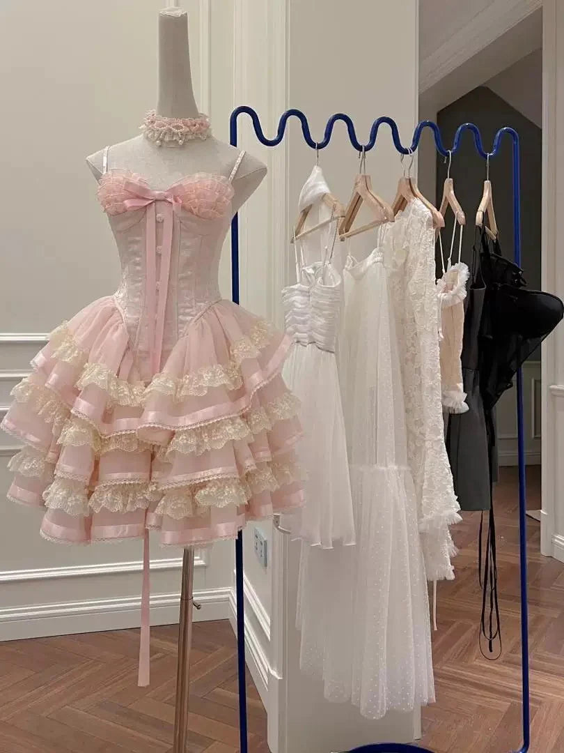 Full view of pink halter corset dress with tiered lace ruffled skirt.
