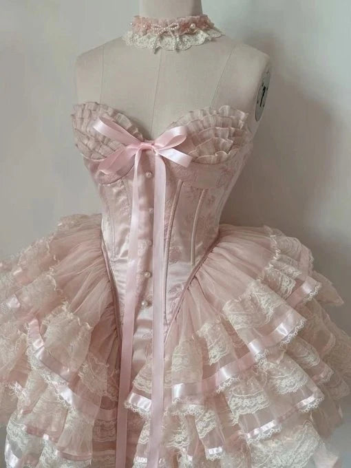 Back view of pink halter corset dress showing lace-up detail.