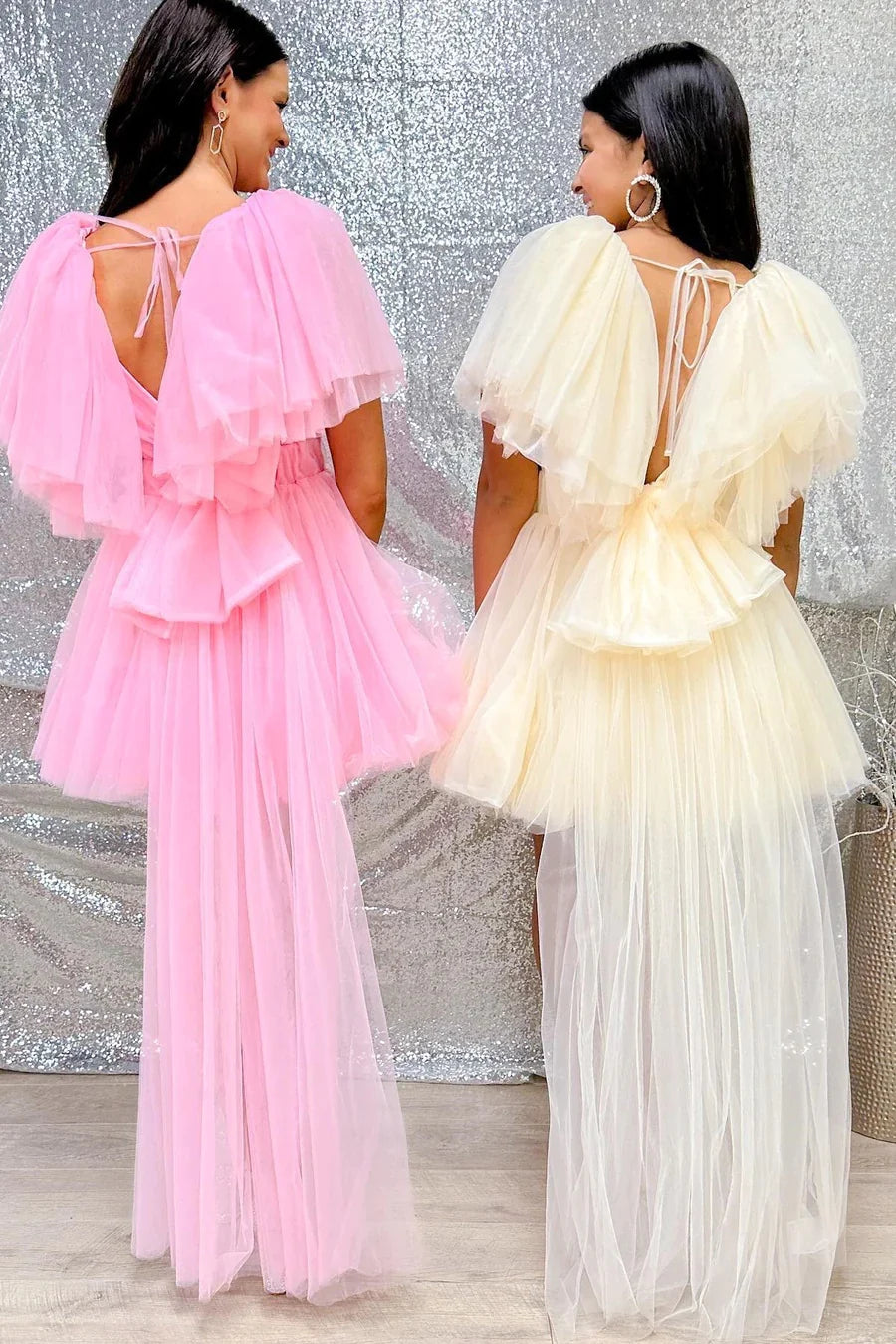Side view of a model in a pink plunge V A-line flutter sleeve homecoming dress.