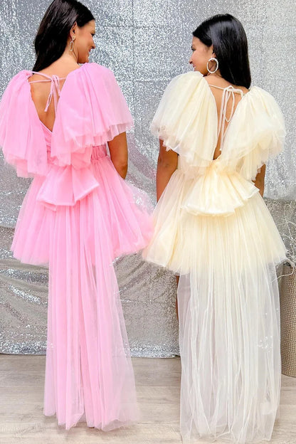 Side view of a model in a pink plunge V A-line flutter sleeve homecoming dress.