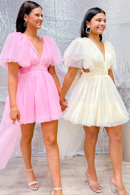 Back view of a pink plunge V A-line homecoming dress with flutter sleeves on a model.
