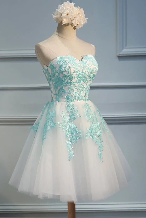 Model wearing a white tulle party dress with sweetheart neckline.