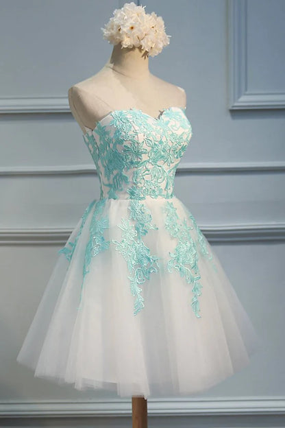 Model wearing a white tulle party dress with sweetheart neckline.