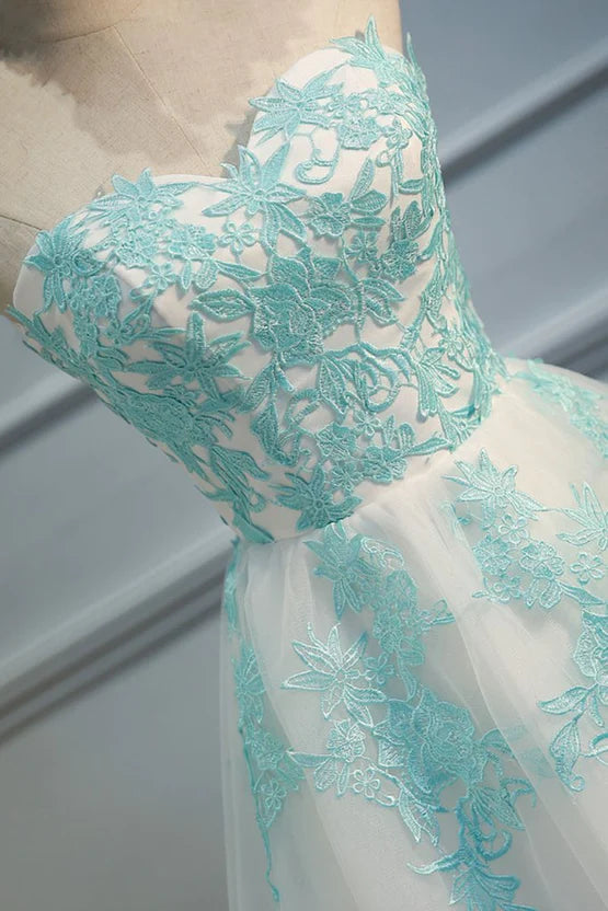 Side profile of a woman in a white sweetheart tulle dress.