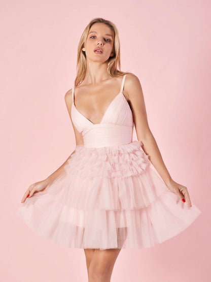 Model wearing a chic A-line deep V-neck short tiered homecoming dress.