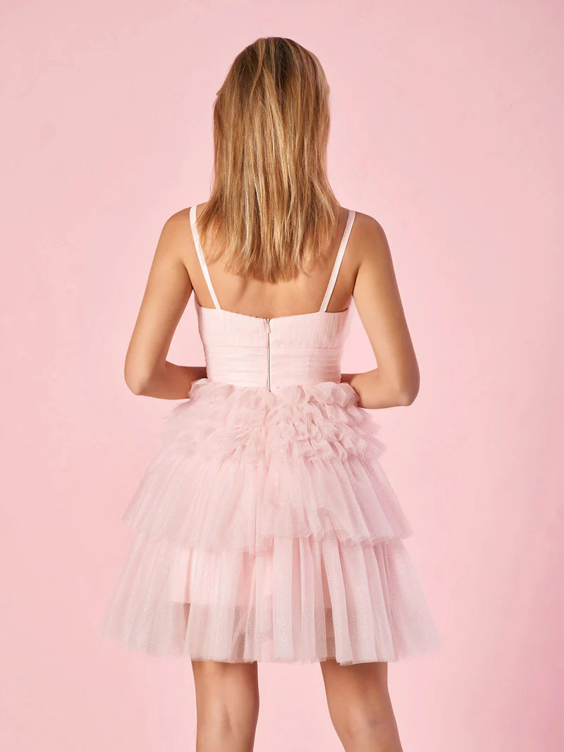 Close-up of the deep V-neckline and tiered skirt detail on the homecoming dress.