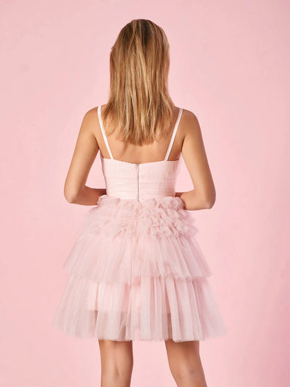 Close-up of the deep V-neckline and tiered skirt detail on the homecoming dress.