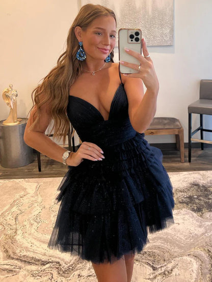 Model gracefully posing in the short tiered A-line formal dress.