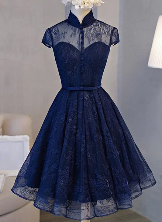 Model wearing a dark navy high neck lace short homecoming dress with a lace-up back.