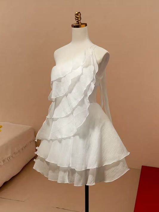 Woman wearing a chic one-shoulder ruffle short chiffon dress.