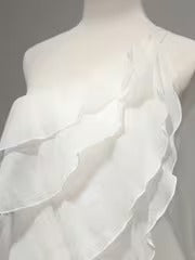 Close-up of the ruffle detail on a one-shoulder dress.