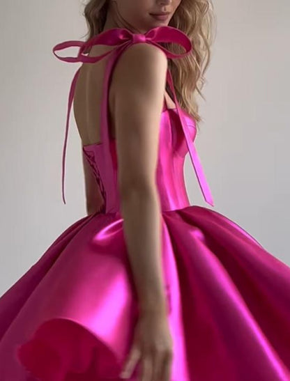 Side view of a short pink satin dress with spaghetti straps.