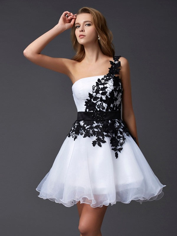 Model wearing a periwinkle A-Line Princess one-shoulder short homecoming dress with lace and organza details.