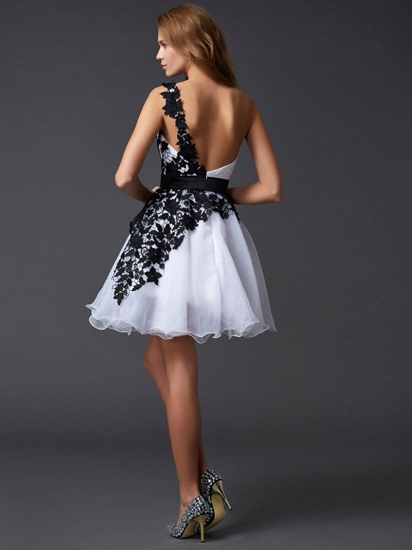 Close-up of the lace and organza fabric on the A-Line Princess one-shoulder homecoming dress.