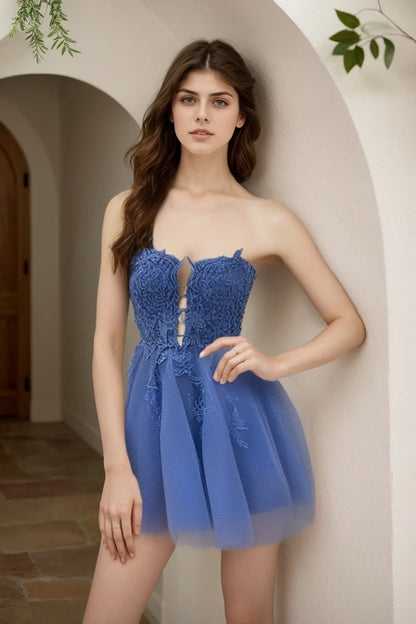 Navy A-line strapless dress showing tulle fabric and applique details.