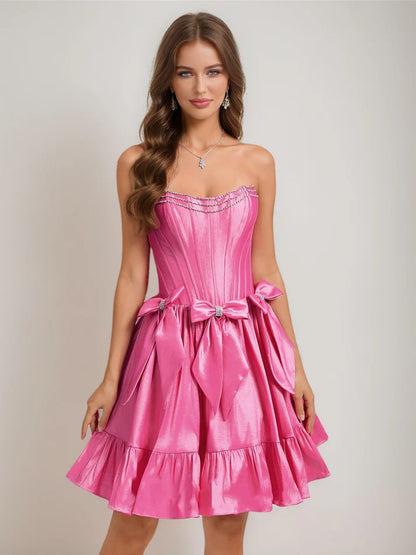 Front view of a chic A-Line strapless short homecoming dress with ruffles, rhinestones, and a bow.