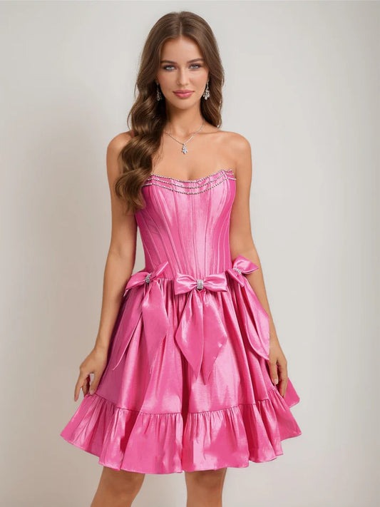 Front view of a chic A-Line strapless short homecoming dress with ruffles, rhinestones, and a bow.