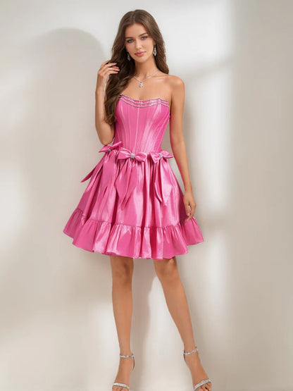 Close-up of the strapless bodice with sparkling rhinestones and a delicate bow on the A-Line homecoming dress.