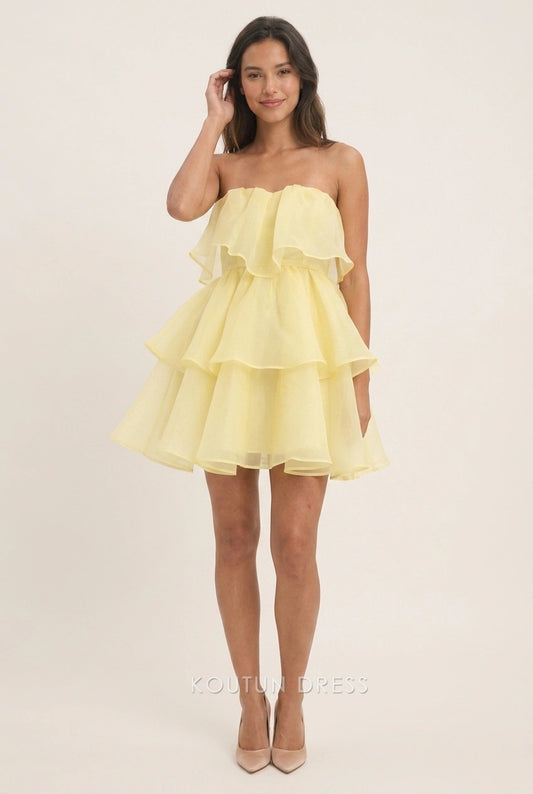 Model wearing a pale yellow strapless ruffled A-line mini homecoming dress.