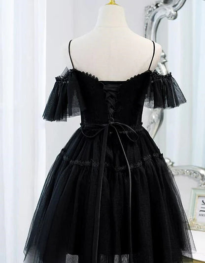 Side view of the black tulle off-shoulder dress, highlighting the A-line skirt.