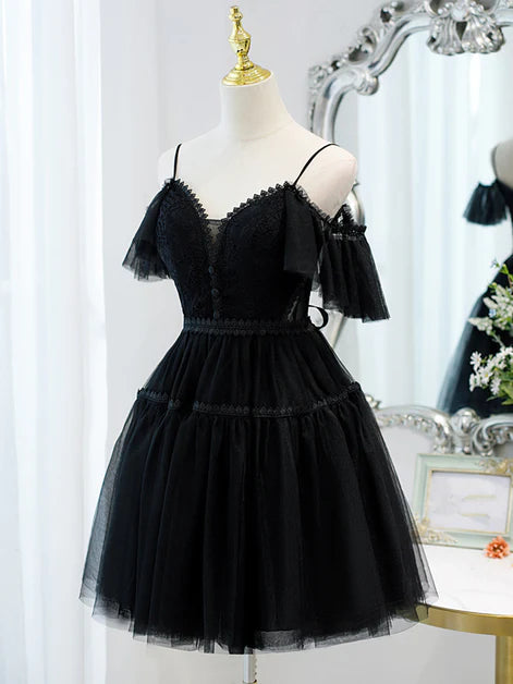 Close-up of the black tulle fabric and sweetheart neckline with off-shoulder straps.