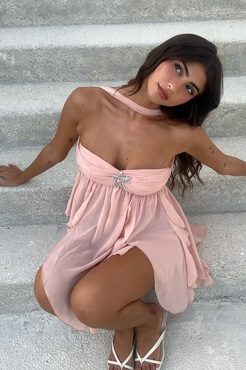 Detail of the ruffles on the hem of the pink A-line dress.