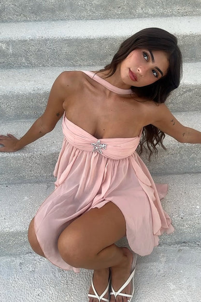 Detail of the ruffles on the hem of the pink A-line dress.