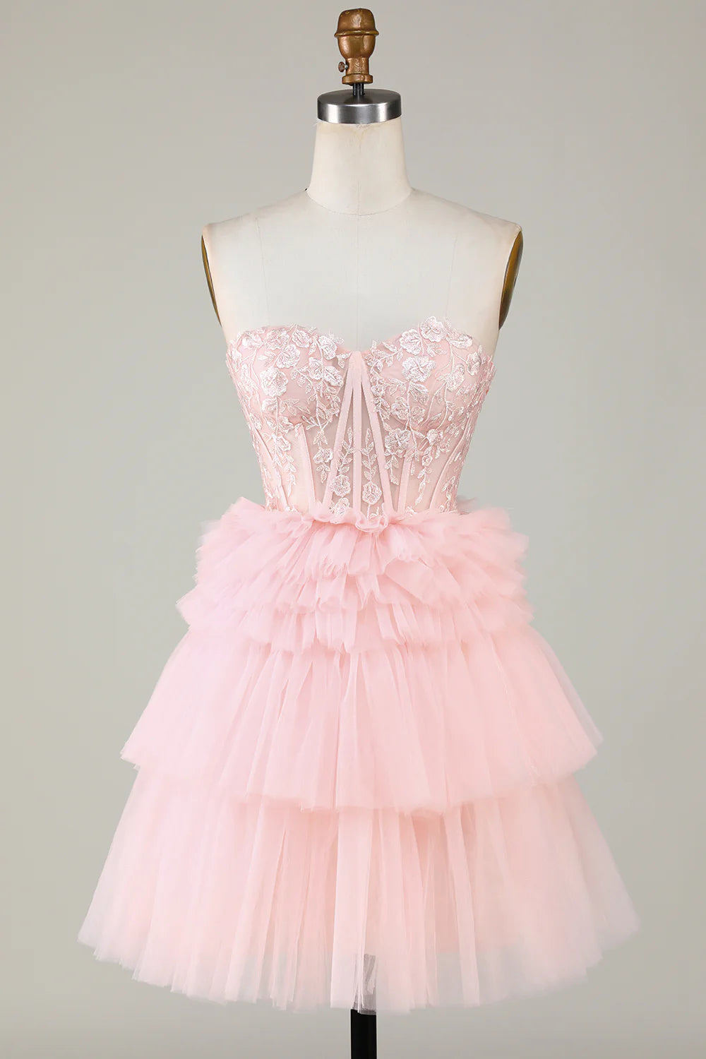 Full view of a model wearing the pink A-line sweetheart ruffled dress.