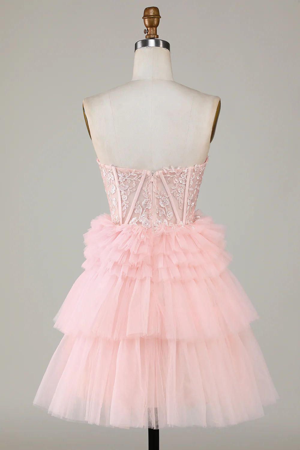 Model posing in the pink A-line sweetheart ruffled short dress, back view.