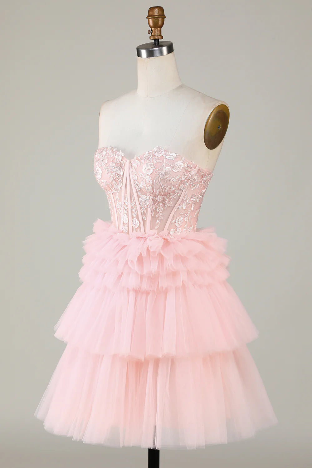 Model in the pink A-line sweetheart ruffled short dress, side profile.