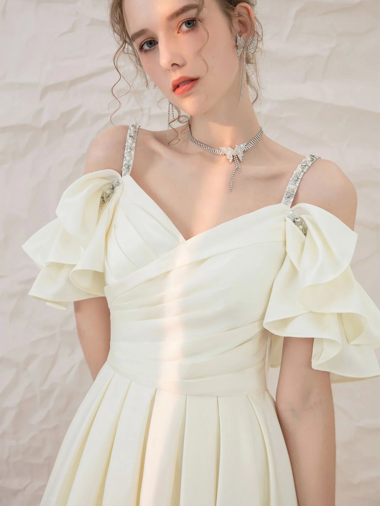 Close-up of the light yellow satin fabric and sweetheart neckline.