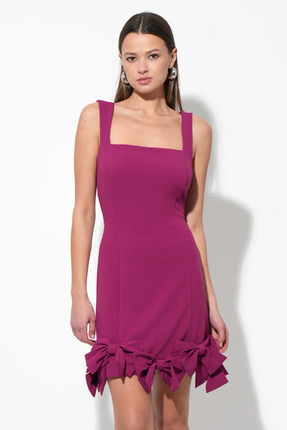 Back view of the A-line mini dress, highlighting the bow detail on the skirt.