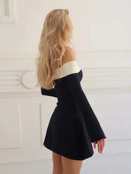 Close-up of the off-shoulder neckline and long flared sleeve on the dress.