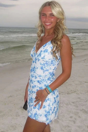 Model wearing a V-neck print bodycon homecoming dress with spaghetti straps, front view.