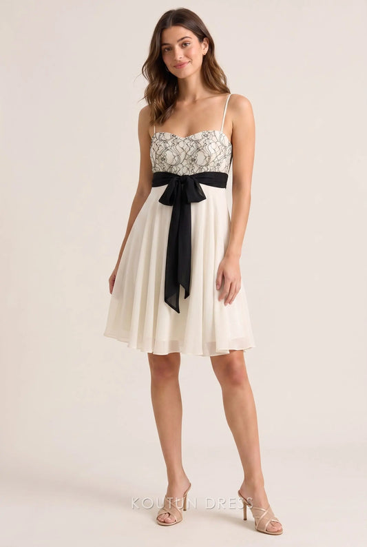 Ivory white A-line homecoming dress with lace bustier and black bow tie.