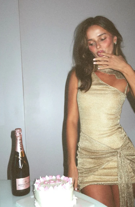 Model wearing a chic black sheath short party dress.
