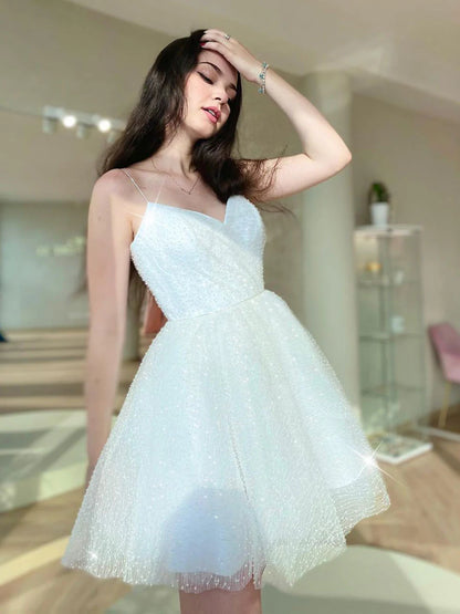 Back view of a model in a sparkling white mini prom dress.