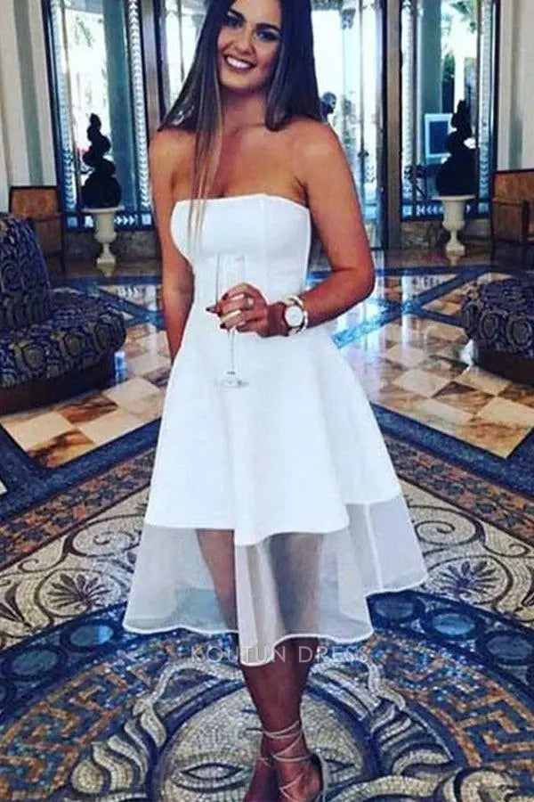 Side view of white knee-length homecoming dress with flowy tulle overlay.