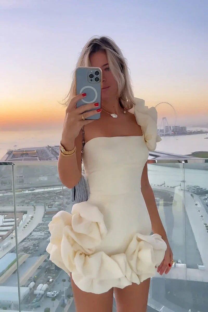 Model posing in a chic strapless ruffled bodycon dress.