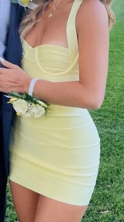 Model wearing a classy sheath mini dress with a sweetheart neckline.