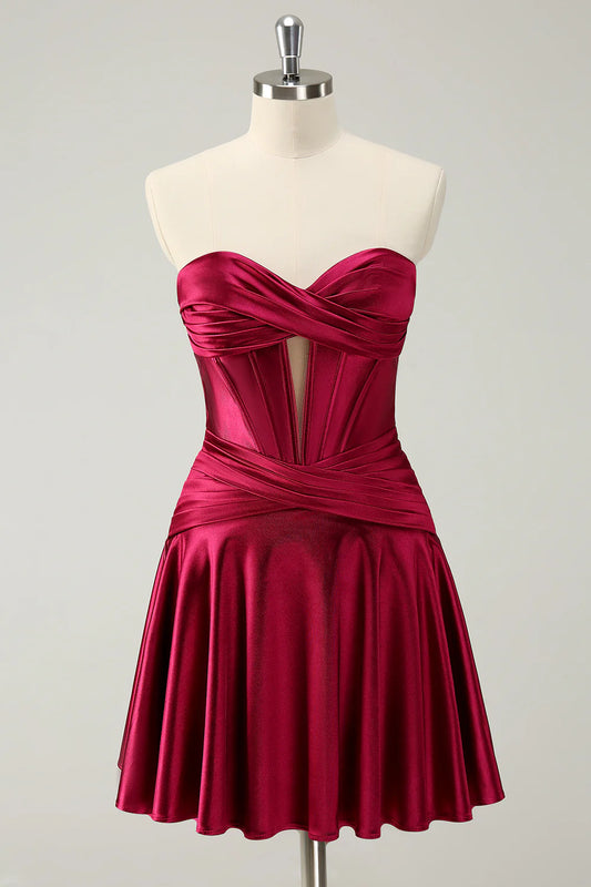 Burgundy A-line satin homecoming dress with sweetheart strapless neckline.