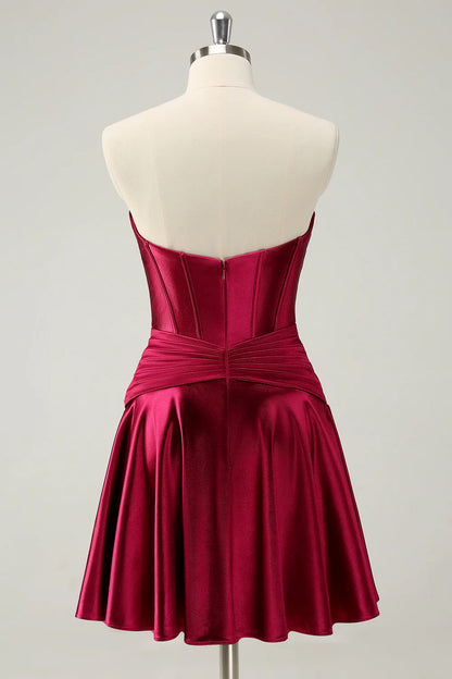 Back view of burgundy A-line satin dress with keyhole detail.