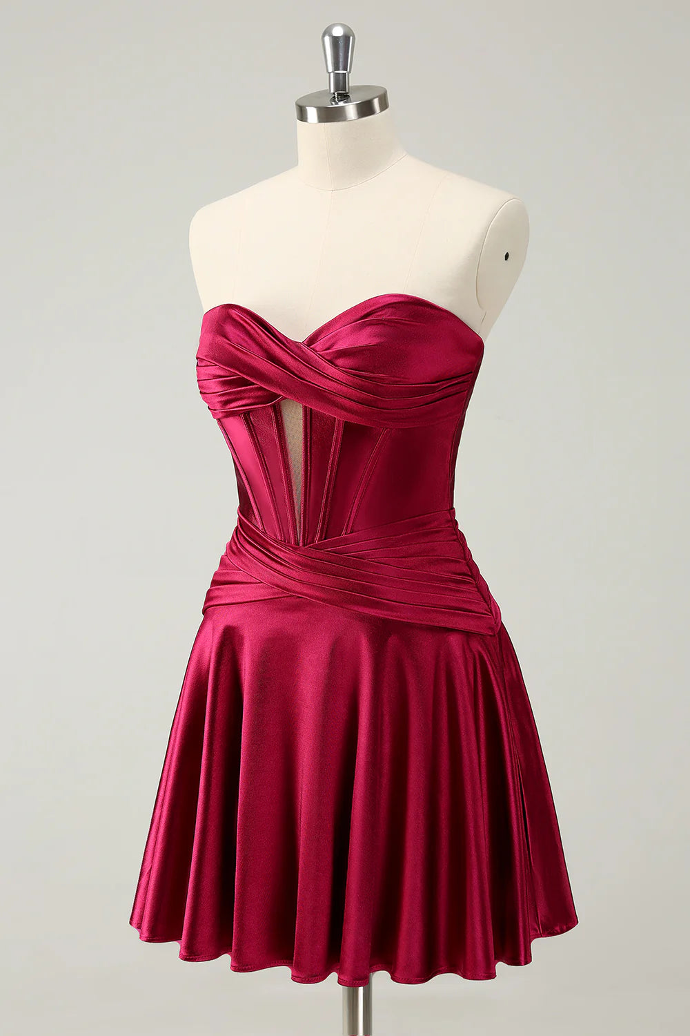 Side view of model wearing burgundy strapless A-line dress.