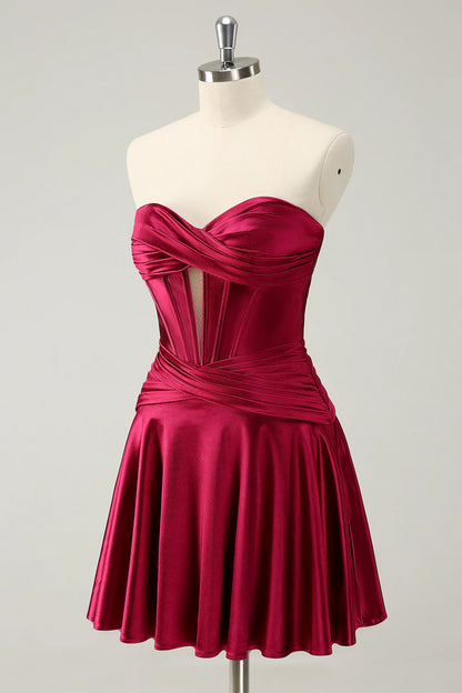 Side view of model wearing burgundy strapless A-line dress.