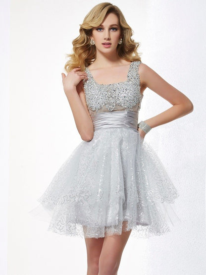 Dazzling A-Line Princess short homecoming dress with beading and straps.