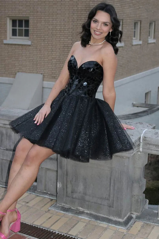 Black A-line strapless homecoming dress with mirror-cut sequins.