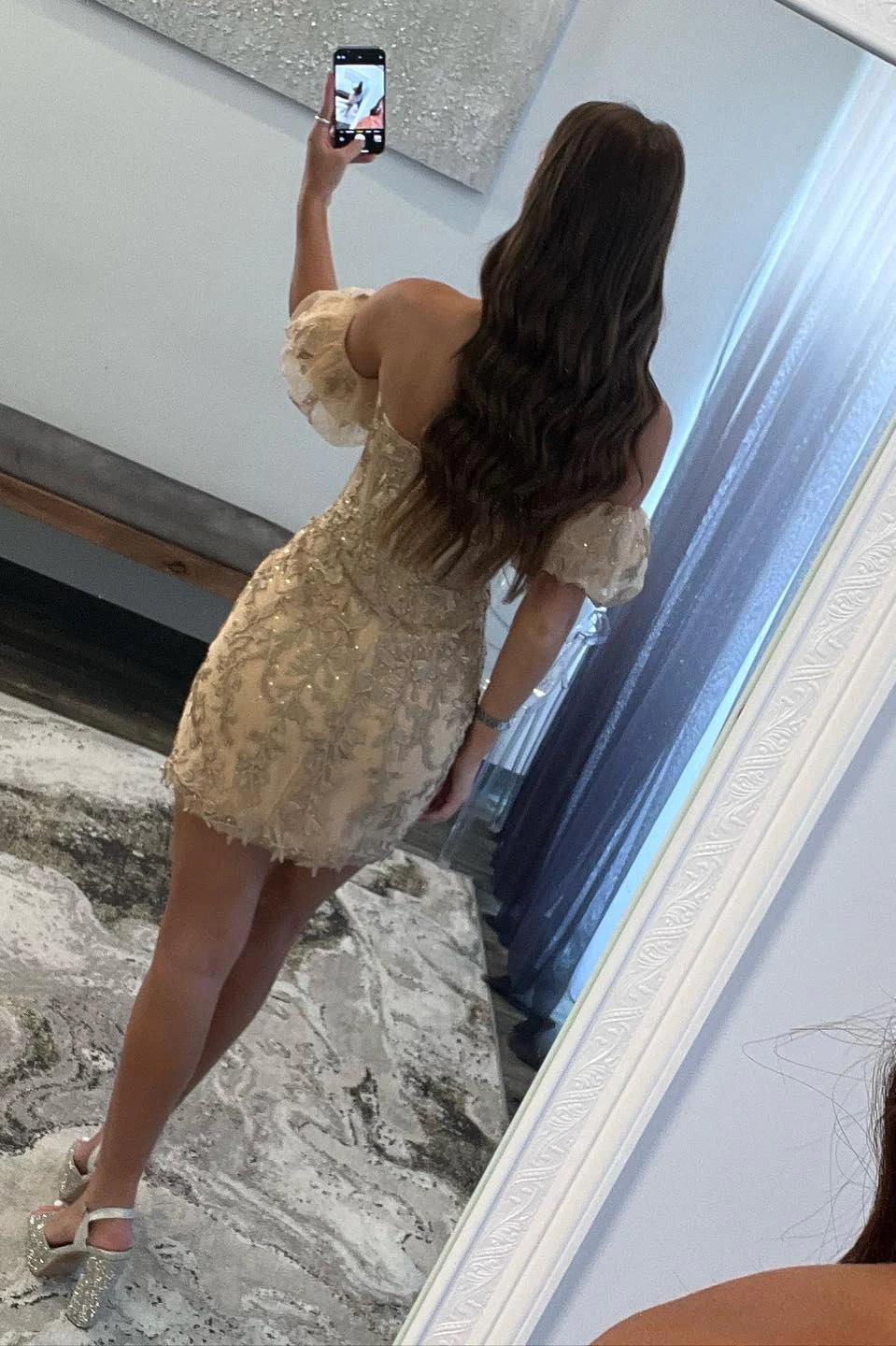 Back view of the gold strapless bodycon dress, showcasing the balloon sleeves.